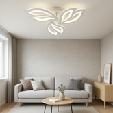 Lustra LED 19250/3WH cu design floral alb si lumina reglabila 3000–6500K, cu telecomanda, amplasata in living modern de dimensiune medie.