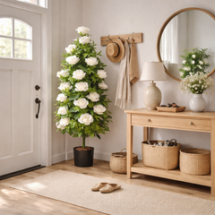 Planta artificiala decorativa cu trandafiri albi, 135 cm, in ghiveci negru, amplasata in coltul unui hol de intrare modern.