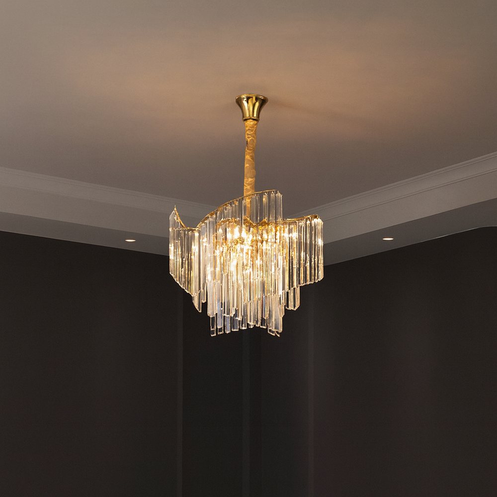 Candelabru modern cu 5 surse E27, finisaj auriu lucios si elemente transparente, lumineaza elegant livingul cu efect decorativ rafinat.