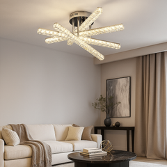 Lustra LED JB001-5 cu 5 brate incrucisate cristalizate, lumina reglabila si telecomanda, iluminand un living modern elegant.
